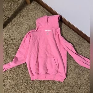 this hoodie has a lovely pink color with white lettering and its a size small